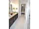 Bathroom with double vanity, granite countertop and view of bedroom at 135 Ventosa Pl, Nokomis, FL 34275