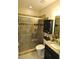 Updated bathroom with a walk-in shower and granite vanity at 135 Ventosa Pl, Nokomis, FL 34275