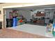 Spacious two-car garage with ample storage shelving and flooring at 135 Ventosa Pl, Nokomis, FL 34275