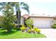 Charming home with a well-manicured front yard, lush landscaping, and a brick driveway at 135 Ventosa Pl, Nokomis, FL 34275