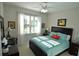 Guest bedroom with a queen bed and window with natural light at 135 Ventosa Pl, Nokomis, FL 34275