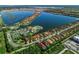Aerial view of Toscana Isles community with lake and homes at 135 Ventosa Pl, Nokomis, FL 34275