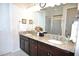 Double vanity bathroom with granite countertops and walk-in shower at 135 Ventosa Pl, Nokomis, FL 34275