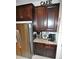 Coffee bar with granite countertop, stainless steel appliances, and dark wood cabinets at 135 Ventosa Pl, Nokomis, FL 34275