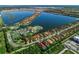 Aerial view of Toscana Isles community with lake and homes at 135 Ventosa Pl, Nokomis, FL 34275