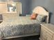 Spacious main bedroom with white furniture and blue walls at 1446 56Th W St # 1446, Bradenton, FL 34209