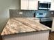 Close-up of kitchen's granite countertop and backsplash at 1446 56Th W St # 1446, Bradenton, FL 34209