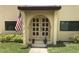 Building entrance with double doors and red tile roof at 1446 56Th W St # 1446, Bradenton, FL 34209