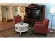 Living area with two armchairs, a coffee table, and a TV stand at 1446 56Th W St # 1446, Bradenton, FL 34209