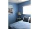 Bright bedroom with a queen-size bed and beach-themed decor at 1446 56Th W St # 1446, Bradenton, FL 34209