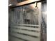 Shower with glass sliding door and marble tile at 1446 56Th W St # 1446, Bradenton, FL 34209