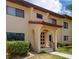 Building exterior with red tile roof and lush landscaping at 1446 56Th W St # 1446, Bradenton, FL 34209