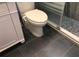 Bathroom with modern toilet and dark grey tile floor at 1446 56Th W St # 1446, Bradenton, FL 34209