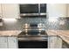 Stainless steel range and microwave in updated kitchen at 1446 56Th W St # 1446, Bradenton, FL 34209