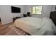Bedroom with large TV, work area, and ample space at 1508 Pelican Cove Rd # Gr233, Sarasota, FL 34231