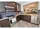 Modern kitchen with dark cabinetry, stainless steel appliances, and granite countertops at 1508 Pelican Cove Rd # Gr233, Sarasota, FL 34231