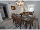 Bright dining area with glass table and brown leather chairs, view into kitchen at 1508 Pelican Cove Rd # Gr233, Sarasota, FL 34231