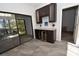 Wet bar with wine fridge, granite countertop and access to screened patio at 1508 Pelican Cove Rd # Gr233, Sarasota, FL 34231