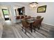 Elegant dining room with a glass table, brown leather chairs, and modern chandelier at 1508 Pelican Cove Rd # Gr233, Sarasota, FL 34231