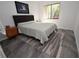 Spacious bedroom with queen bed, wood nightstand, and large window at 1508 Pelican Cove Rd # Gr233, Sarasota, FL 34231