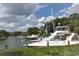 Calm marina with several boats and lush vegetation at 1508 Pelican Cove Rd # Gr233, Sarasota, FL 34231