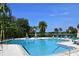 Inviting community pool with lounge chairs and waterfront views at 1508 Pelican Cove Rd # Gr233, Sarasota, FL 34231