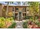 Condo building exterior with stairs and tropical landscaping at 1608 Bayhouse Point Dr # 401, Sarasota, FL 34231