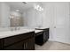 Bathroom featuring double sinks, modern fixtures, and a large mirror at 16112 Isola Pl, Bradenton, FL 34211