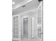 Hallway with French doors, white trim, and neutral color palette at 16112 Isola Pl, Bradenton, FL 34211