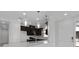 Bright kitchen featuring stainless steel appliances, dark cabinets and pendant lights at 16112 Isola Pl, Bradenton, FL 34211