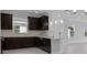 Modern kitchen featuring dark wood cabinets, marble backsplash, and pendant lighting at 16112 Isola Pl, Bradenton, FL 34211