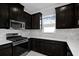 Stylish kitchen features stainless steel appliances and sleek dark cabinetry at 16112 Isola Pl, Bradenton, FL 34211