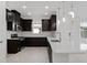 Modern kitchen with dark wood cabinets, stainless steel appliances, and a bright white countertop at 16112 Isola Pl, Bradenton, FL 34211