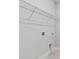 Laundry room with wire shelving and tiled floor provides a functional and organized space at 16112 Isola Pl, Bradenton, FL 34211