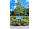 Community pollinator garden full of colorful flowers, with an informative sign at 16112 Isola Pl, Bradenton, FL 34211