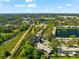 Aerial view of a house situated by a lake and golf course at 1742 Adams S Cir, Largo, FL 33771