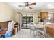 Casual dining area with white table and chairs, sliding glass doors to patio at 1742 Adams S Cir, Largo, FL 33771