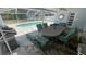 Covered patio with dining set and views of the pool at 1809 Southwood St, Sarasota, FL 34231