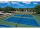 Two blue tennis courts with green perimeter at 2110 Hawthorne St, Sarasota, FL 34239