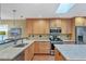 Updated kitchen with wood cabinets, granite countertops, and stainless steel appliances at 2110 Hawthorne St, Sarasota, FL 34239