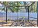 Relaxing screened patio with table and chairs, perfect for outdoor dining at 2110 Hawthorne St, Sarasota, FL 34239