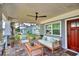 Relaxing front porch with comfortable seating and ceiling fan at 2110 Hawthorne St, Sarasota, FL 34239