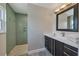 Modern bathroom with green walk-in shower and dark wood vanity at 2110 Hawthorne St, Sarasota, FL 34239