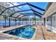 Inviting screened pool with brick pavers and a covered patio at 2110 Hawthorne St, Sarasota, FL 34239