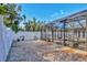 Gravel backyard with white fence and pool enclosure at 2110 Hawthorne St, Sarasota, FL 34239