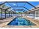 Inviting screened pool with brick pavers and a covered patio at 2110 Hawthorne St, Sarasota, FL 34239