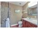 Updated bathroom with mosaic tile shower and wood vanity at 2110 Hawthorne St, Sarasota, FL 34239