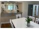 Dining area with white table and chairs, kitchen view at 232 Nina Way, Oldsmar, FL 34677