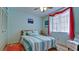 Bedroom with striped bedding and light wood floors at 2901 26Th W St # 818, Bradenton, FL 34205