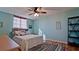 Bedroom with light teal walls, ceiling fan, and wood floors at 2901 26Th W St # 818, Bradenton, FL 34205